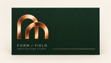 Copper foil geometric logo on a forest green suede soft touch business card